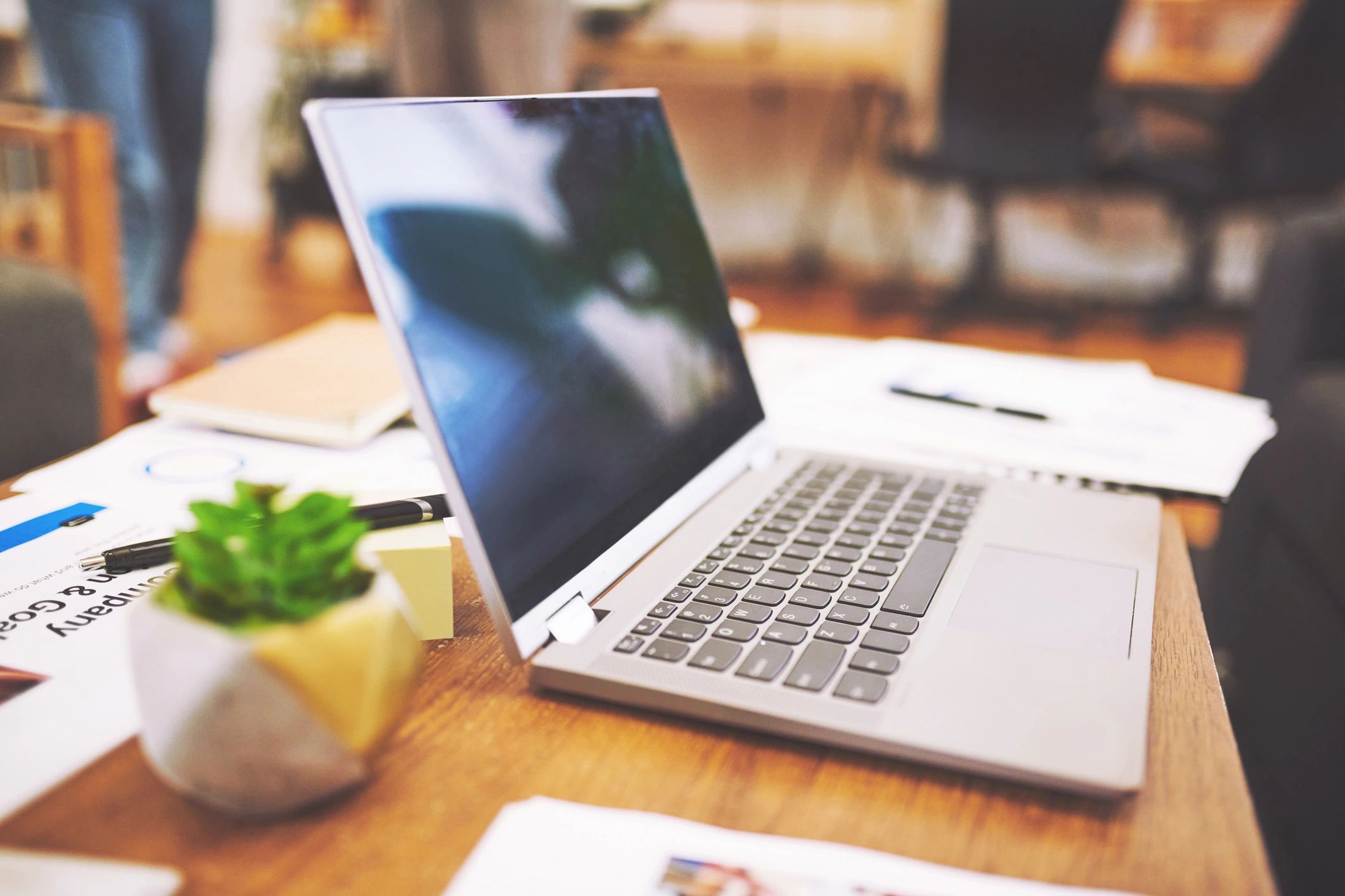 Laptop and paperwork on a desk