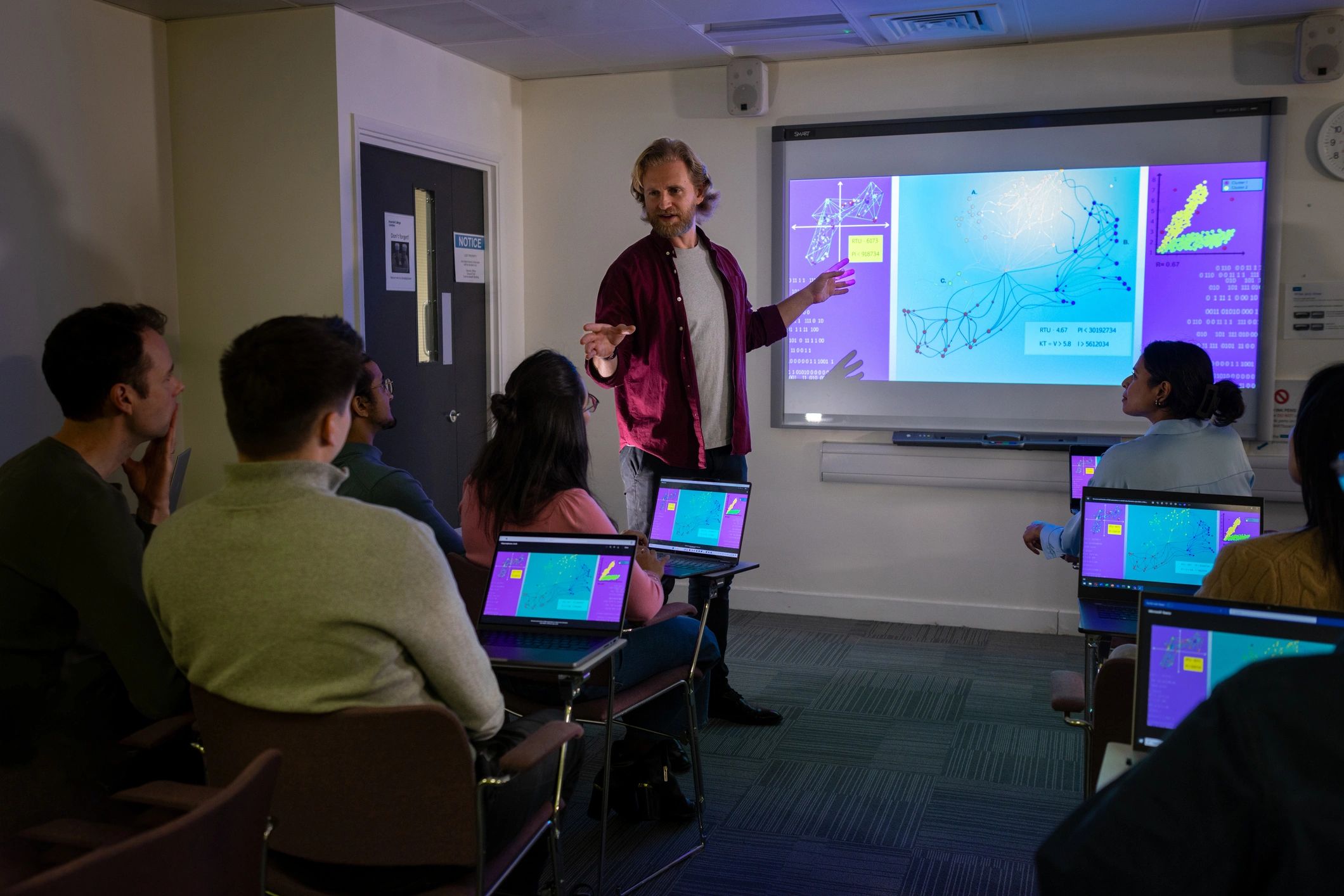Researchers attending a seminar in an auditorium