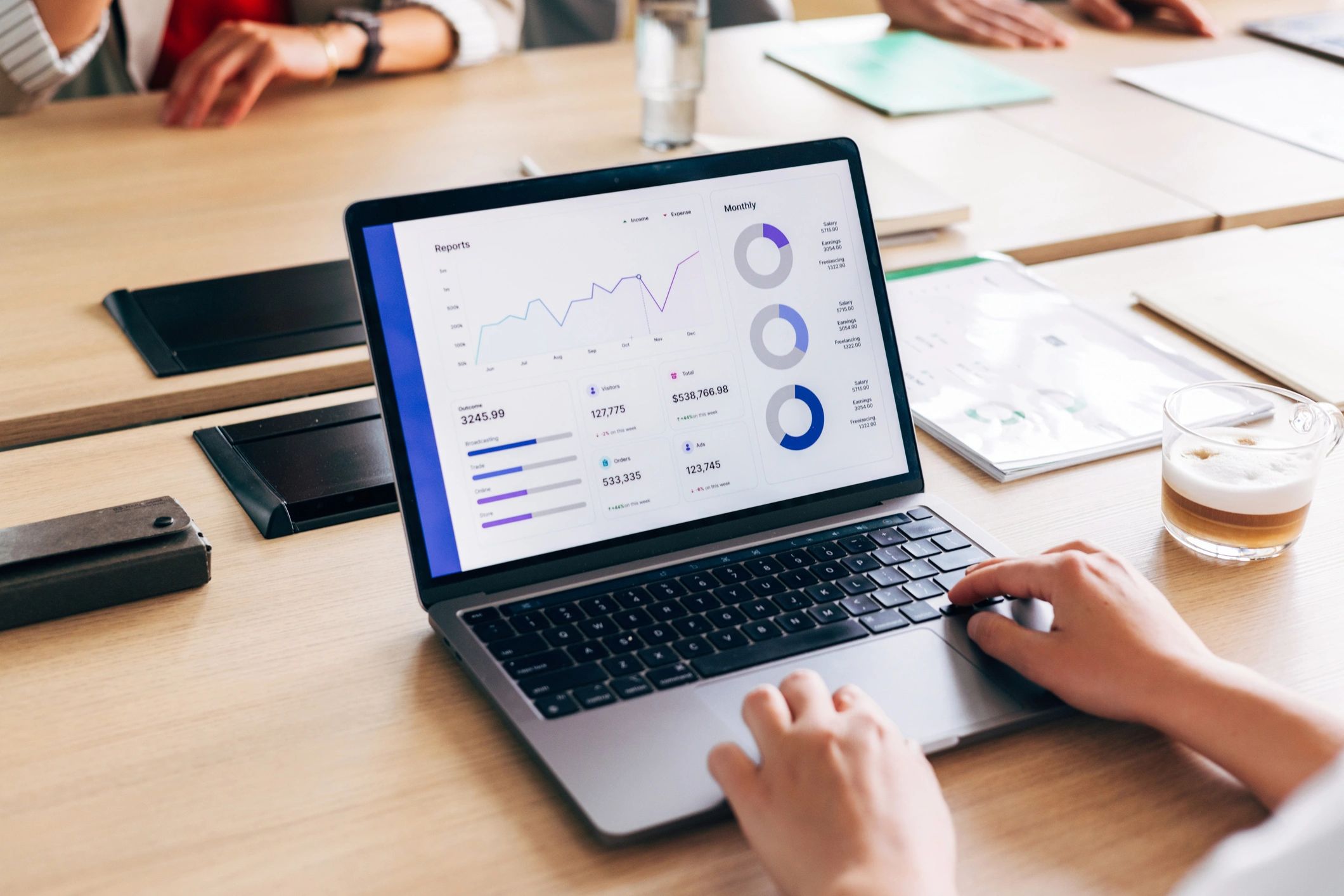Person analyzing data analytics on a laptop